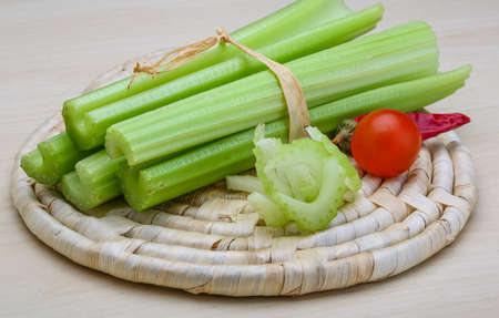 Fresh Green Celery sticks on the wood backgroundの写真素材