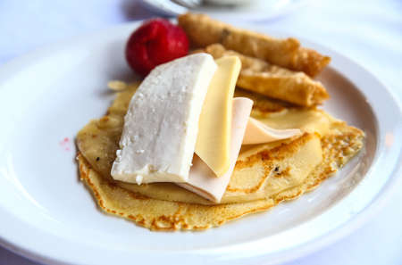 Pancake with cheese and ham served fresh strawberryの写真素材