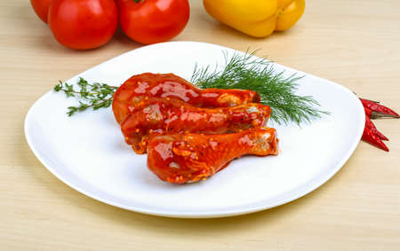 Chicken legs in red tomato sauce with rosemaryの写真素材