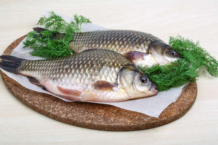 Two crucian with dill ready for cooking
