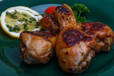 Roasted chicken legs in teriyaki sause with thymeの写真素材