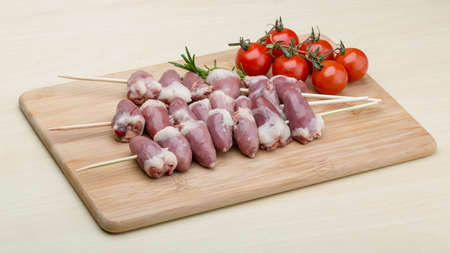 Raw chicken hearts ready for barbecue with rosemaryの写真素材
