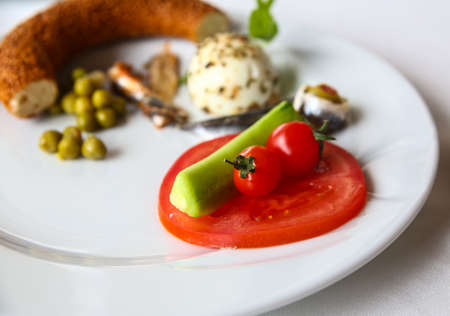 Breakfast with egg, bread, peas, tomato and anchovyの写真素材