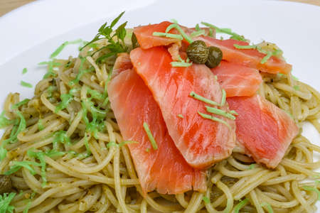 Pasta with salmon, green pesto cheese and capersの写真素材