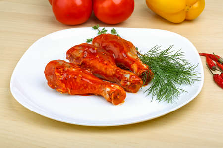 Chicken legs in red tomato sauce with rosemaryの写真素材