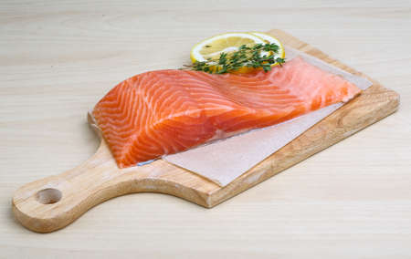 Salted Salmon on the wood background with herbsの写真素材