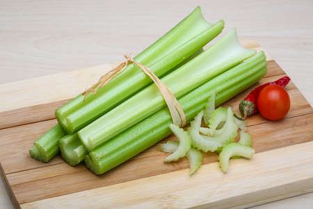Fresh Green Celery sticks on the wood backgroundの写真素材