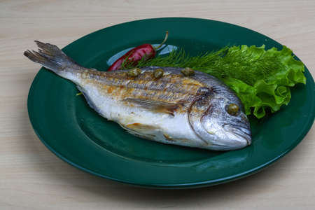 Grilled dorado with salad leaves and dillの写真素材