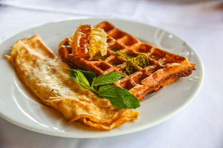 Belgian waffle with honey and fresh mintの写真素材
