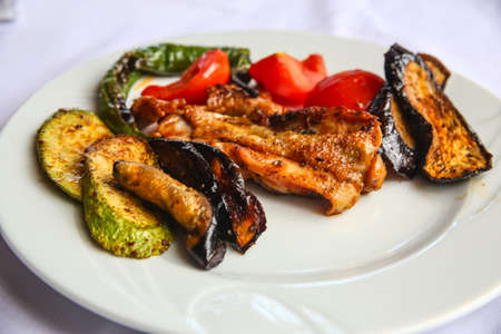 Grilled chicken with vegetables - eggplant, zucchini, tomato, pepperの写真素材
