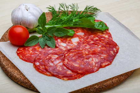 Chorizo sausage - spanish salami on the wood backgroundの写真素材