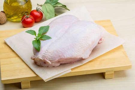 Raw chicken breast with spices ready for cookingの写真素材