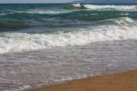 Black sea coast with waves on the beachの写真素材