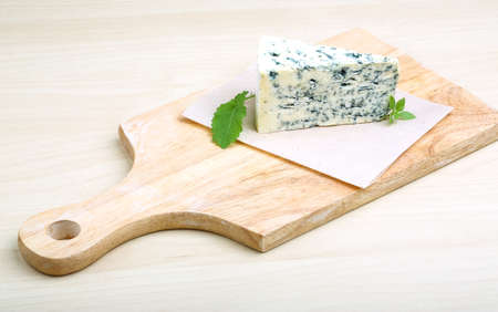 Dor Blue cheese with basil on the wood の写真素材