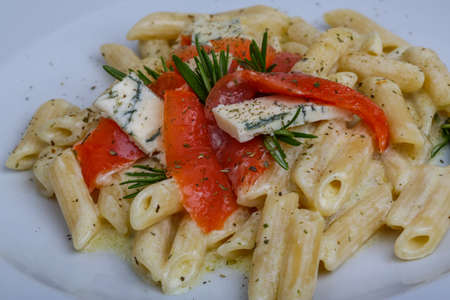 Italian pasta - penne with salmon and blue cheeseの写真素材