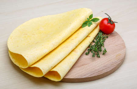 Tortilla stack with herbs on the wood backgroundの写真素材