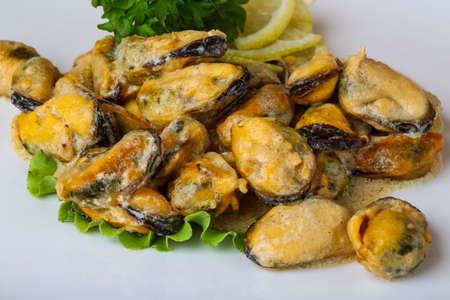 Mussels in butter sauce with lemon and parsleyの写真素材