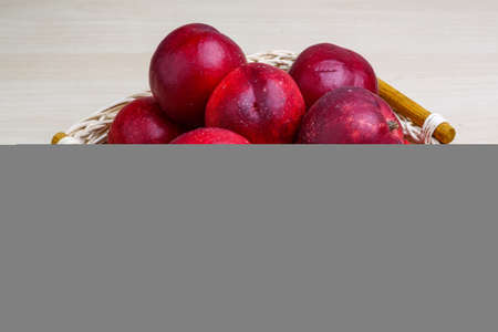 Fresh ripe Nectarines in the wooden plateの写真素材