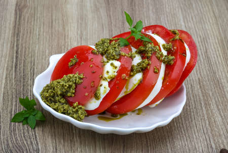 Caprese salad with pesto, mozzarella and basilの写真素材
