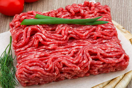 Raw minced beef meat with green oinion and dillの写真素材