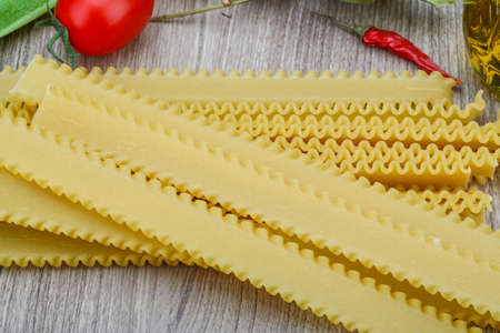 Italian raw Pata Festonate on the wood backgroundの写真素材