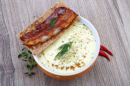 Cheese soup with dill, bacon, spices and herbsの写真素材