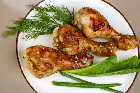 Grilled chicken legs with sesame seeds, dill and green onionの写真素材