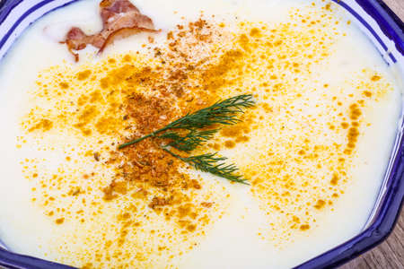 Cheese soup with bacon and herbs on the wood backgroundの写真素材