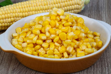 Sweet canned fresh corn on the wood background