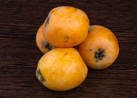 Fresh ripe sweet Medlar on the wood backgroundの写真素材
