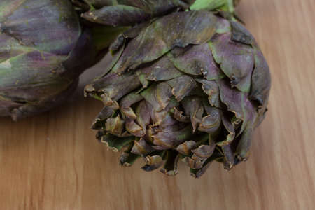 Fresh Raw artichokes on the wooden backgroundの写真素材