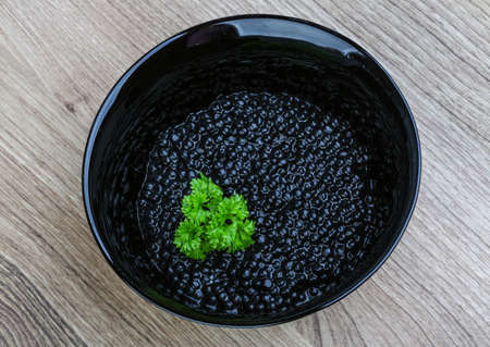 Luxury Black caviar in the bowl with parsley leavesの写真素材