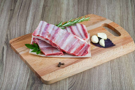 Fresh cold Raw lamb ribs with garlik and pepper - ready for cookingの写真素材