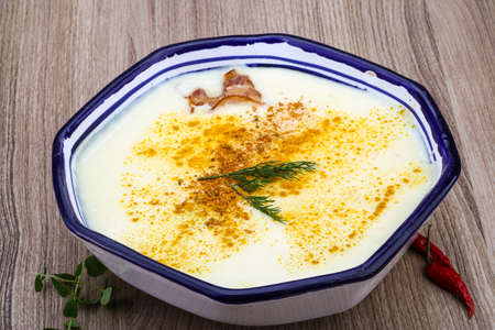 Cheese soup with bacon and herbs on the wood backgroundの写真素材