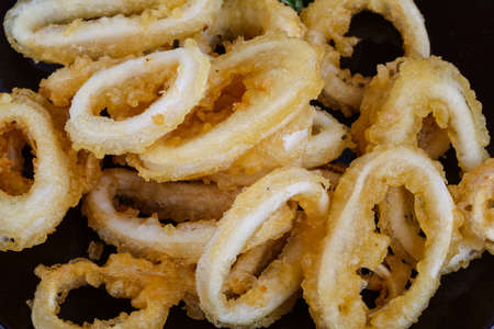 Tempura - squid rings served green onion and rucola leavesの写真素材