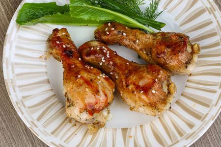 Grilled chicken legs with sesame seeds, dill and green onionの写真素材