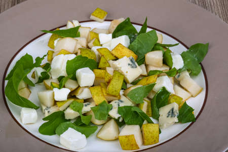 Sweet pear, blue cheese and rucola salad with sesame seedsの写真素材