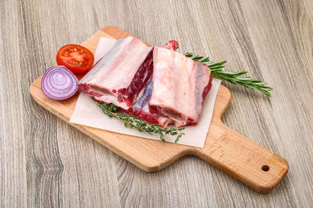 Raw beef ribs with rosemary and thyme - ready for cookingの写真素材
