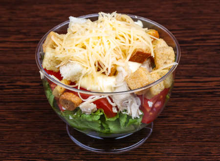 Caesar salad with chicken on the wood backgroundの写真素材
