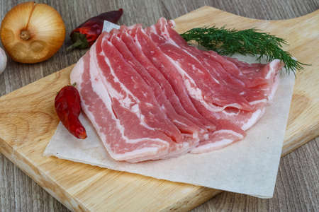 Fresh Raw bacon with dill leaves and hot pepperの写真素材