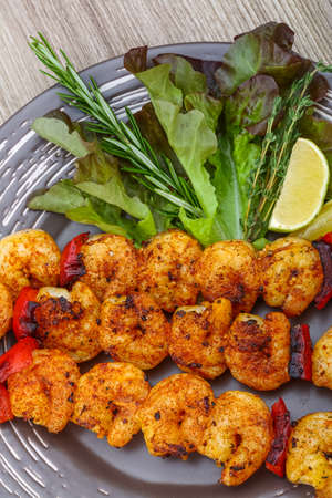 Tiger Prawn skewer with salad leaves and rosemaryの写真素材