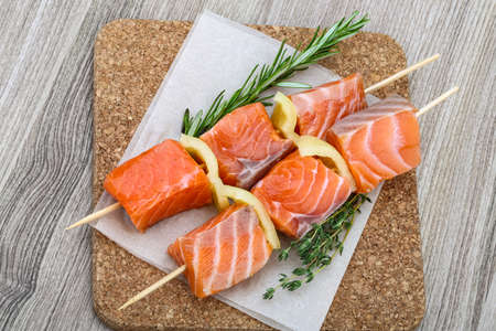 Fresh raw salmon skewer with pepper and rosemaryの写真素材