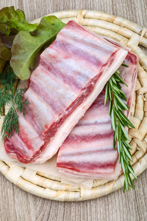 Fresh raw Lamb ribs with rosemary on the wood backgroundの写真素材