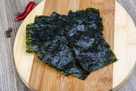 Korean traditional snack - Nori seaweed sheets on the wood backgroundの写真素材