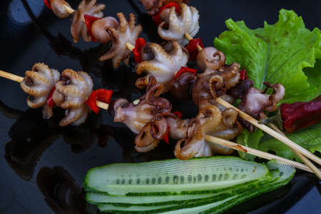Barbecue baby octopus with bell pepper and spicesの写真素材