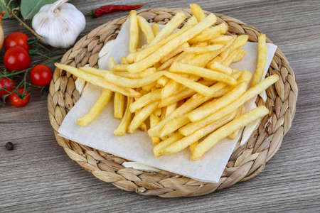 French fries potato on the wood background