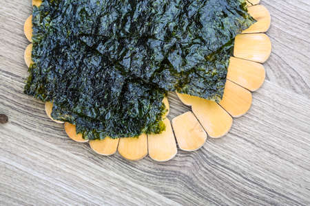 Korean traditional snack - Nori seaweed sheets on the wood backgroundの写真素材