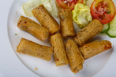 Asian traditional spring rolls on the wood backgroundの写真素材