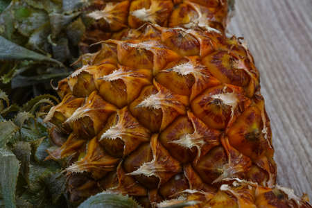 Fresh ripe Small pineapples on the wood backgroundの写真素材