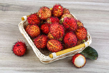 Asian fruit - rambutan - on the wood backgroundの写真素材
